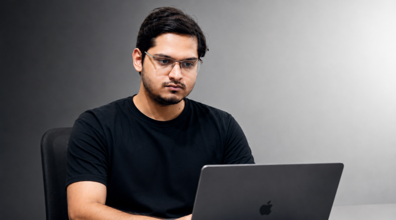 Yatharth Joshi, a social media entrepreneur from India, working on a laptop in a professional tech setting.